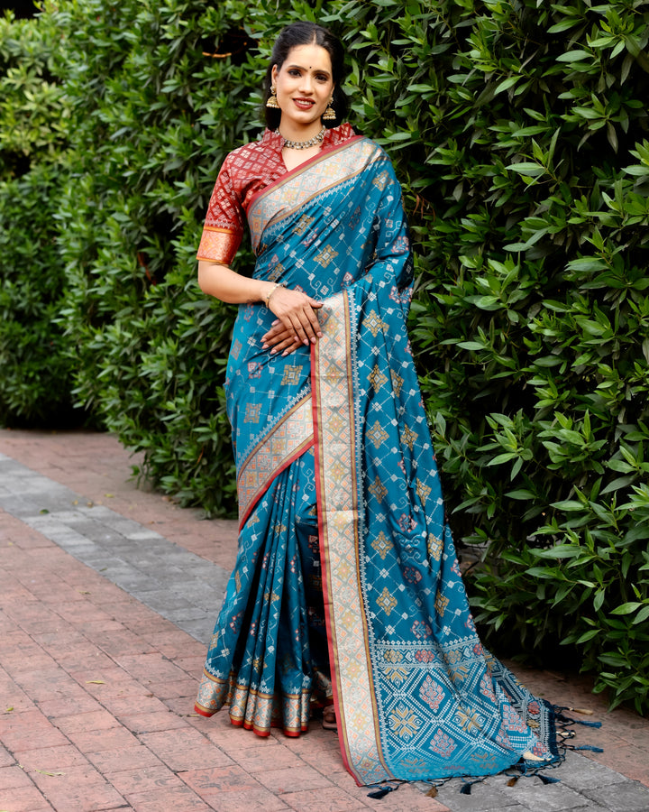 Elevate your festive wardrobe with this teal Ikkat Patola silk saree, featuring Kanchi-style borders and intricate Zari work.