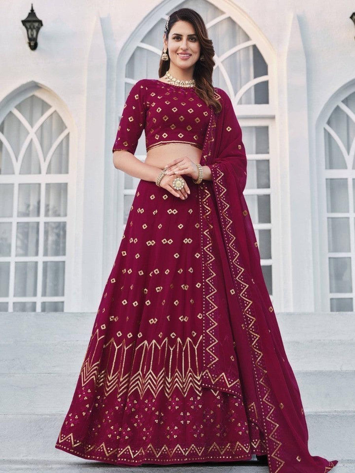 Traditional bridal lehenga choli with deep pink thread and sequin work.