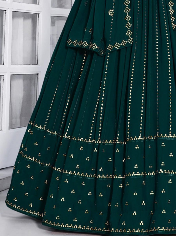 Semi-stitched teal green lehenga with unstitched blouse material.