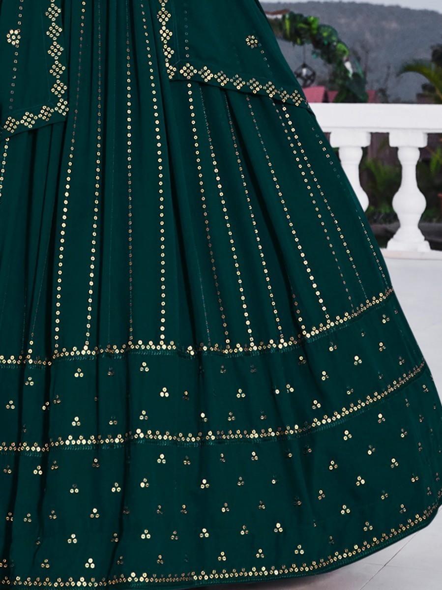 Green lehenga set with embroidered choli and matching dupatta.