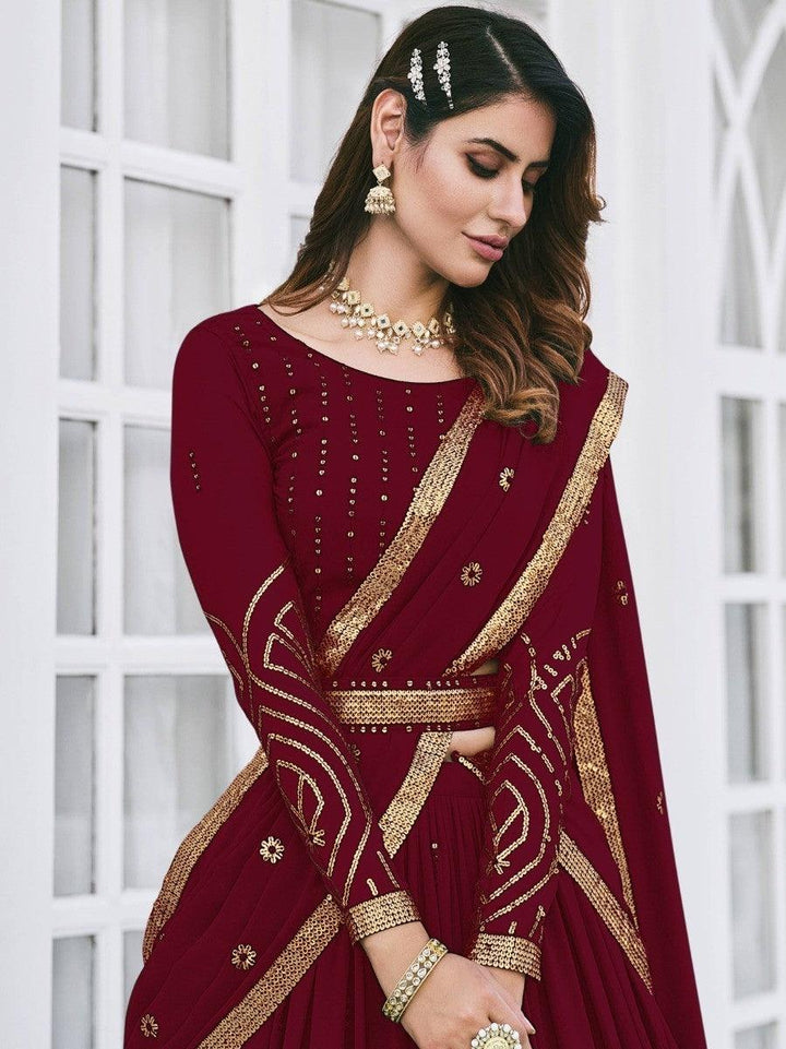 Traditional maroon lehenga choli with matching dupatta and belt.