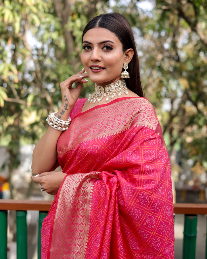 A vibrant bright pink Pure Handloom Bandhej Patola Silk Saree featuring intricate patterns, perfect for an Indian wedding.