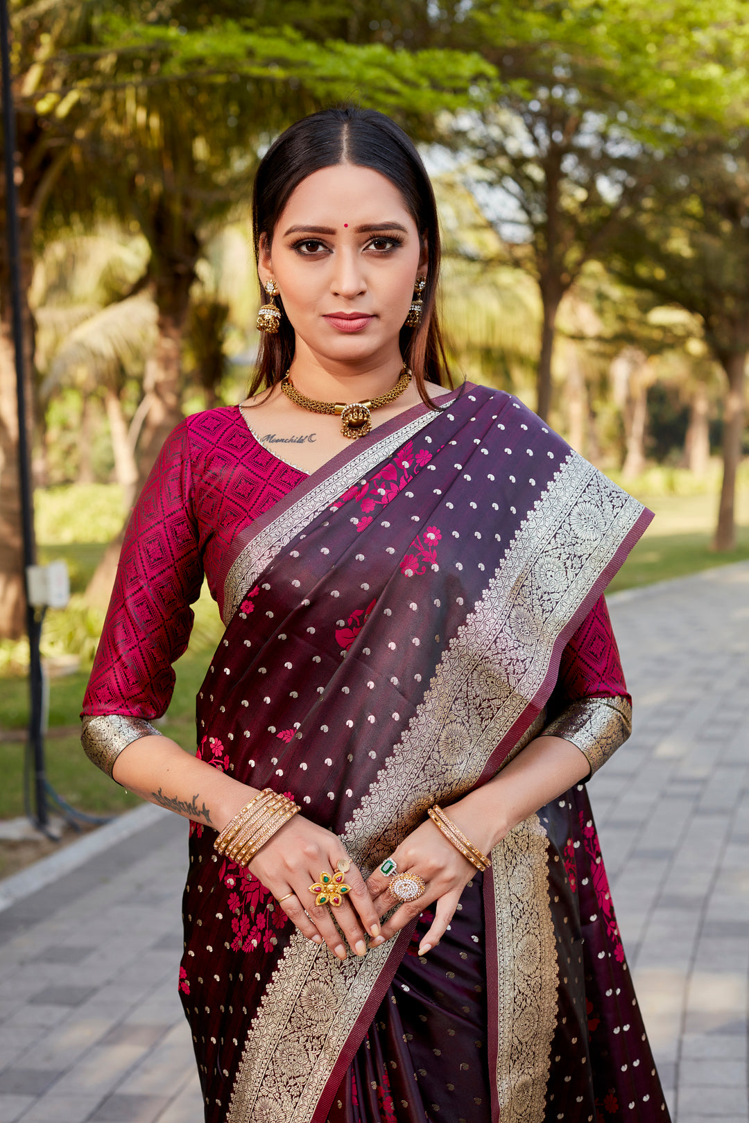 Elegant wine Satin Kanjivaram saree with intricate butta motifs and a glossy shimmer.