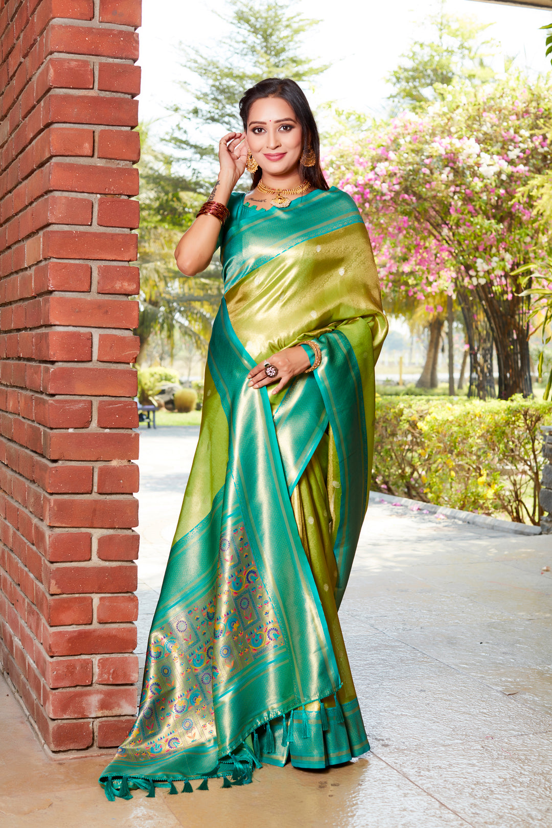 Graceful parrot-green tissue silk saree with a rich pallu and contrasting blouse, perfect for cultural festivities.