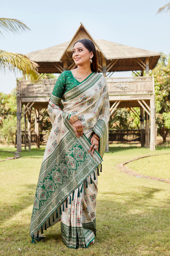 Cream soft silk Kanjivaram saree with intricate designer borders and traditional elegance.