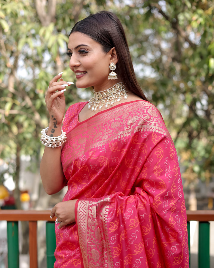 Gorgeous bright-pink Bandhej Patola silk saree with intricate zari work and regal Kanchi borders, perfect for weddings.