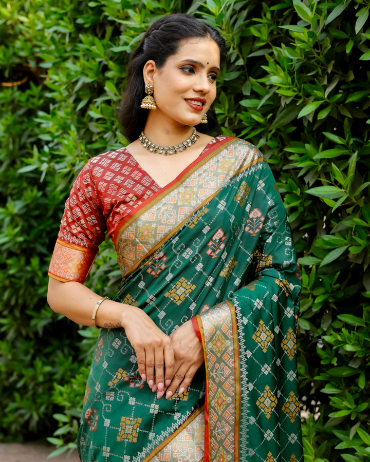 Add a sophisticated touch to your wardrobe with this green Ikkat Patola silk saree, adorned with intricate Zari borders and Kanchi-style detailing.