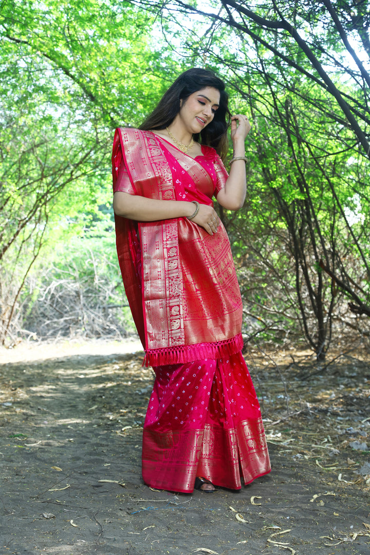 Radiant orange handmade Bandhej Kanjivaram silk saree with beautiful Bandhej design and exquisite border and pallu.