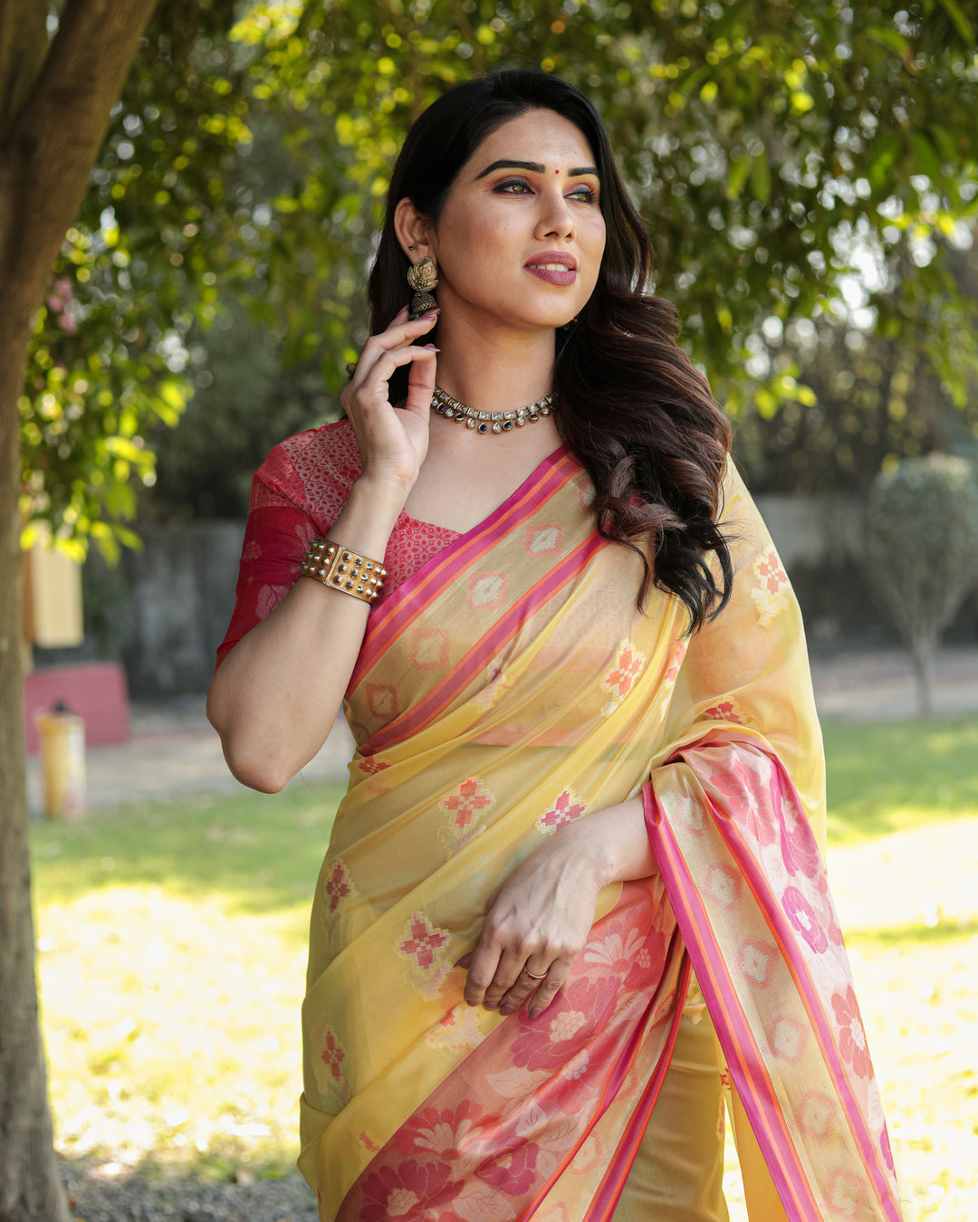 Soft yellow Organza Ikkat weave saree with delicate tassels, ideal for festive and cultural occasions.