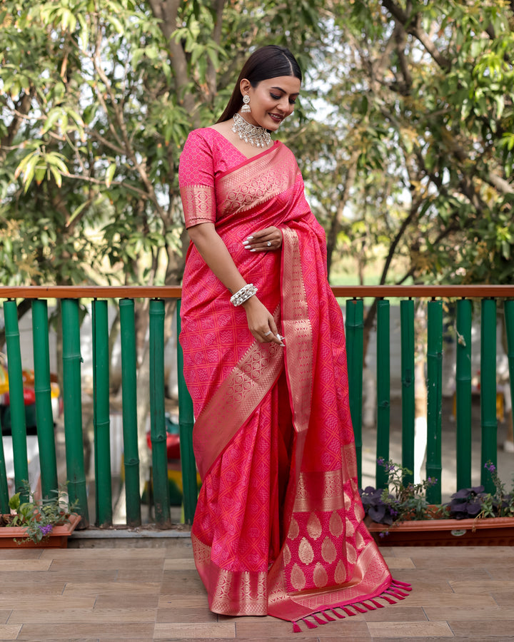 Elegant bright pink saree adorned with Bandhej designs and a dazzling contrast zari border, perfect for celebrations.