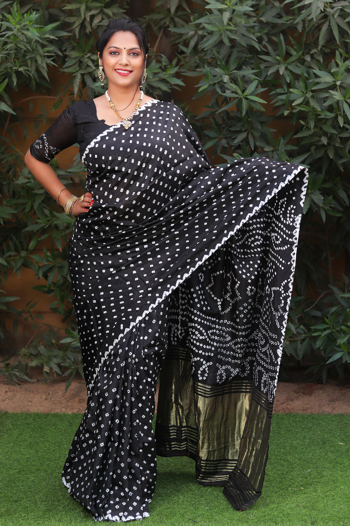 Elegant black Bandhej silk saree with Zari woven pallu, designed for a luxurious and traditional look.