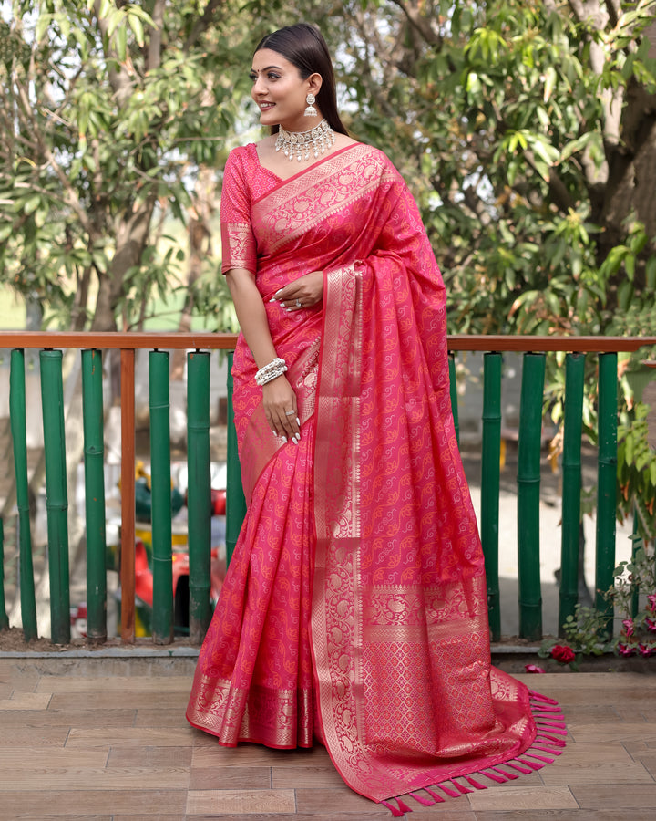 Beautiful bright-pink Bandhej Patola silk saree with rich zari work and Kanchi borders, perfect for traditional events.