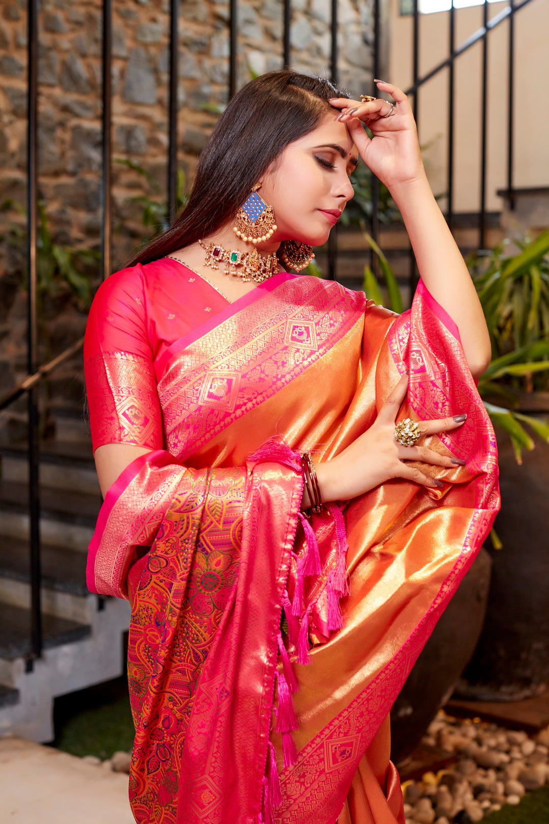 Pink Tissue silk saree with rich weaving and bold contrast border design.