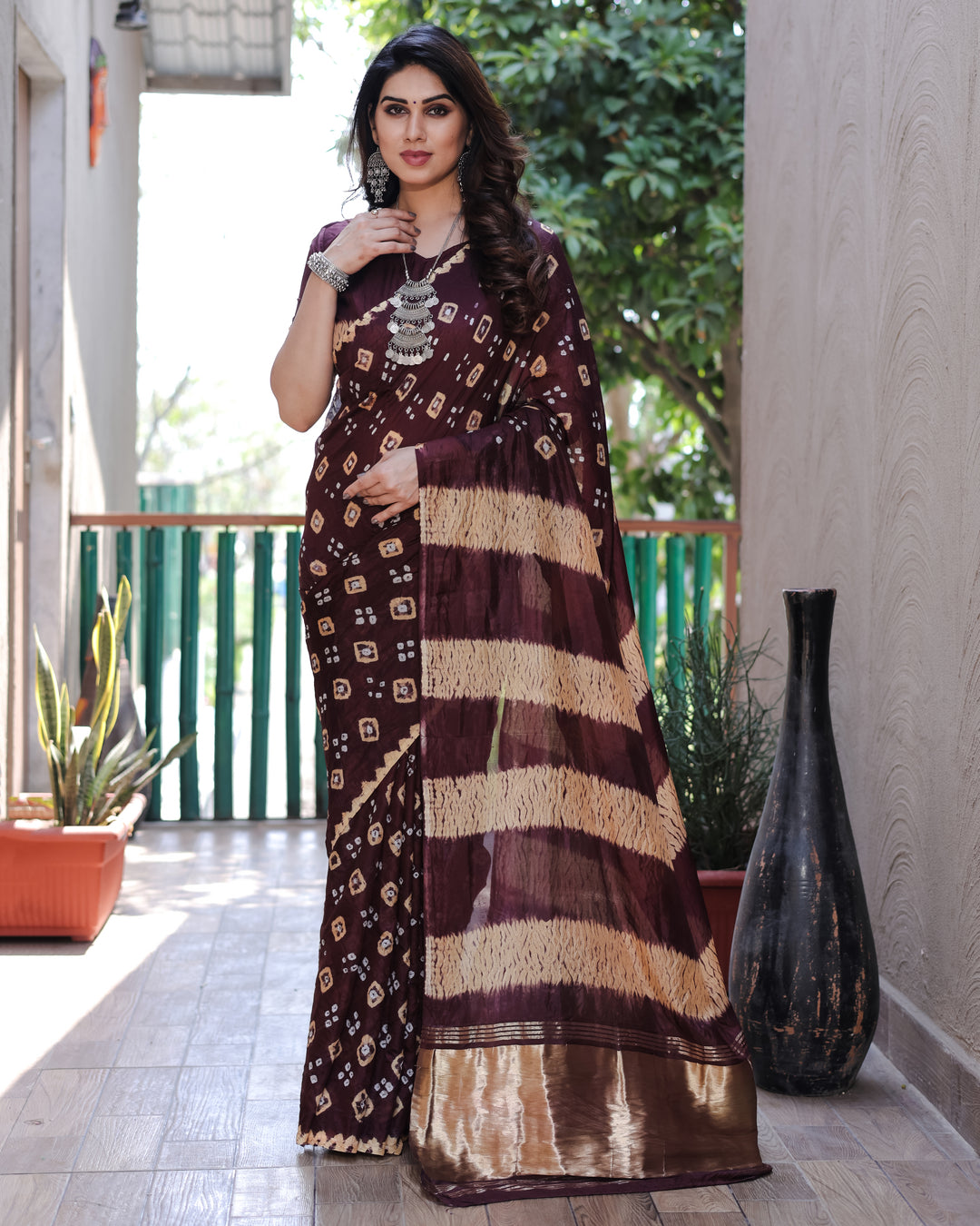 Deep wine Bandhej silk saree with a luxurious tissue pallu and intricate Zari work, designed to impress at every event.