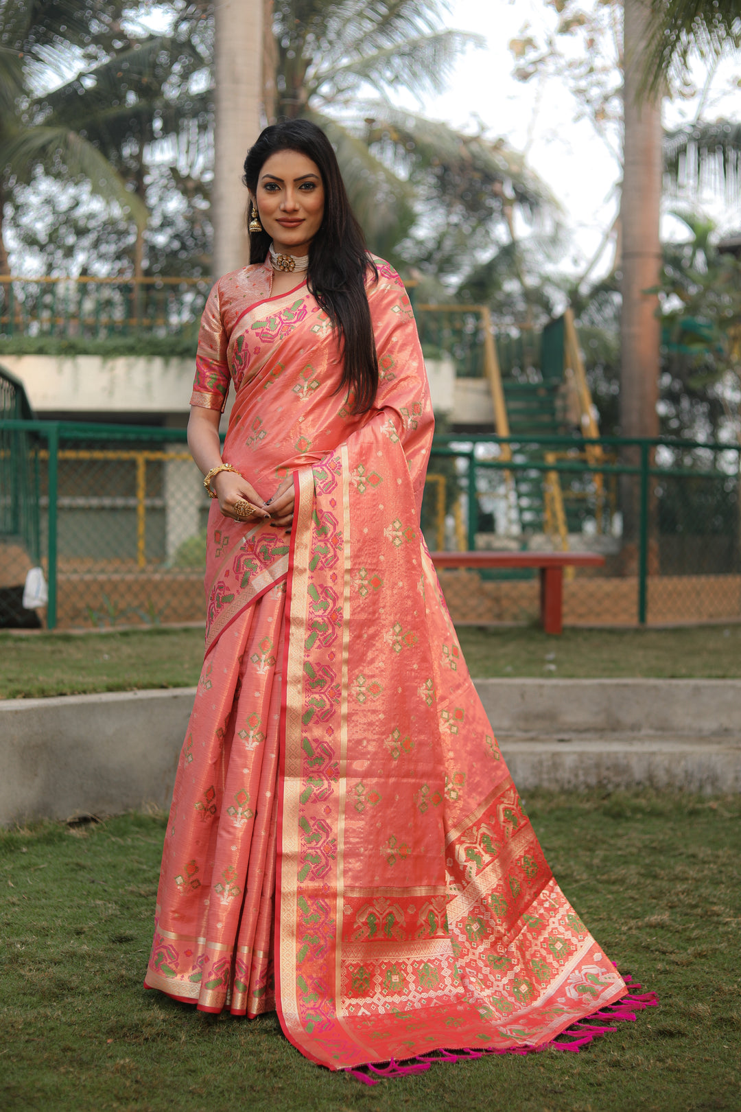 Stunning dark-peach organza saree with delicate Ikkat Patola print, ideal for weddings and festive events.