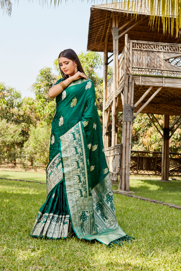 Elegant teal-green satin Kanjivaram saree with a rich elephant border, perfect for weddings and festive occasions.