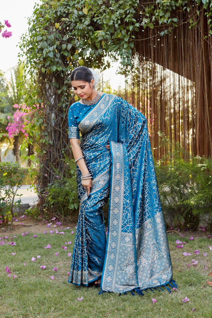 Beautiful blue Kanjivaram soft satin silk saree with intricate butta design, perfect for weddings and formal events.