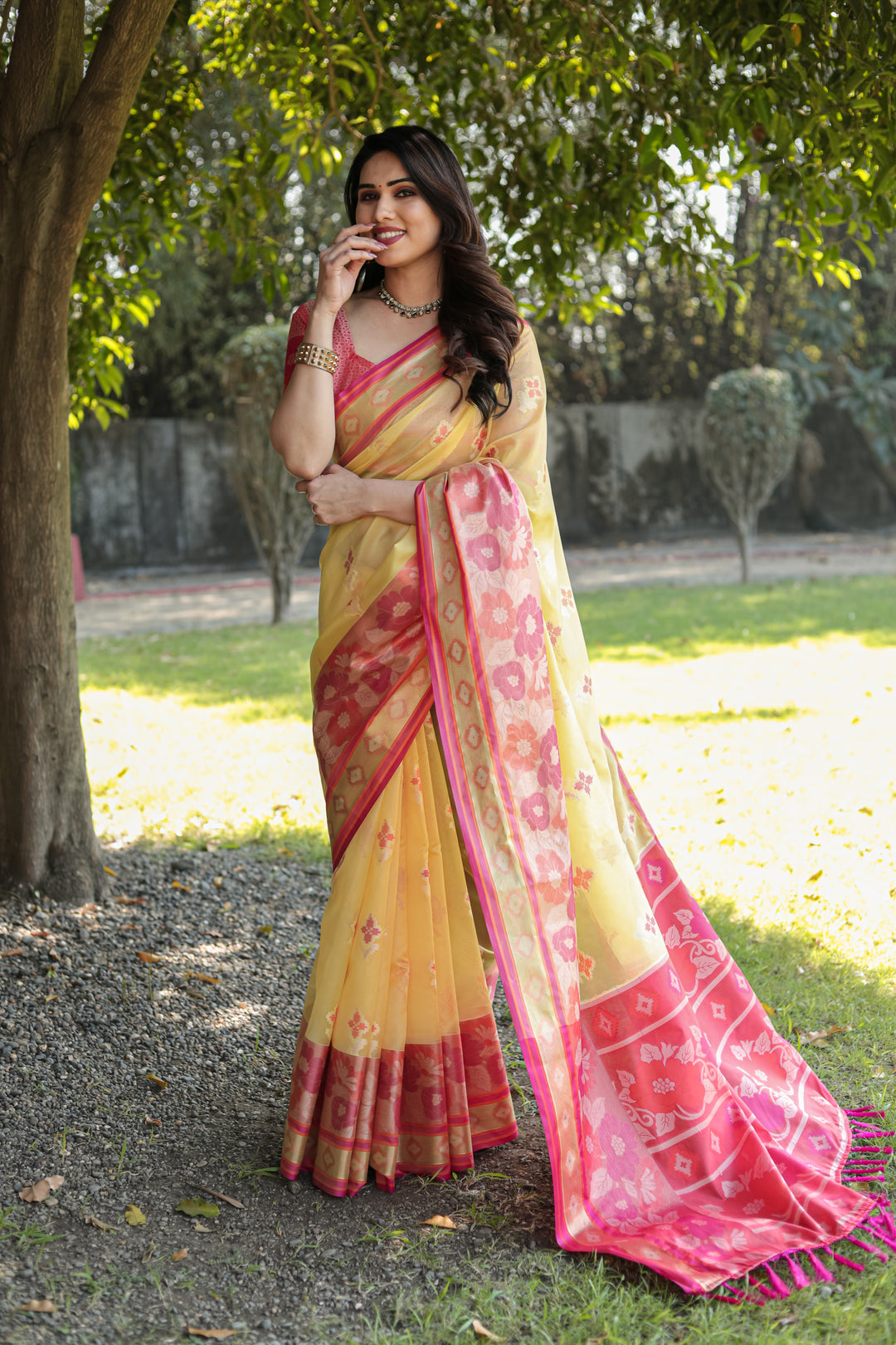 Bright yellow Organza Ikkat weave saree with a matching pallu and tassels, designed for comfort and style.