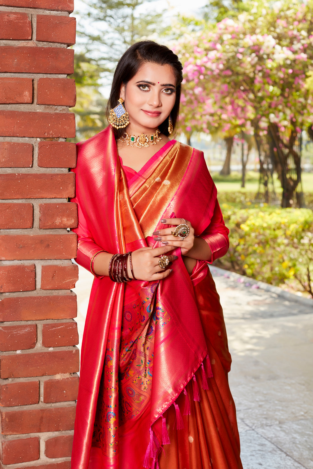 Timeless red tissue silk saree with rich pallu and contrast blouse, perfect for weddings and festivals.