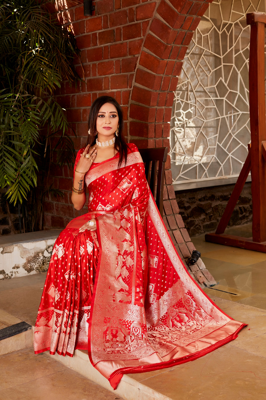 Timeless red Kanjivaram saree with soft satin silk fabric, intricate weaving, and a beautifully crafted pallu, ideal for festive events.