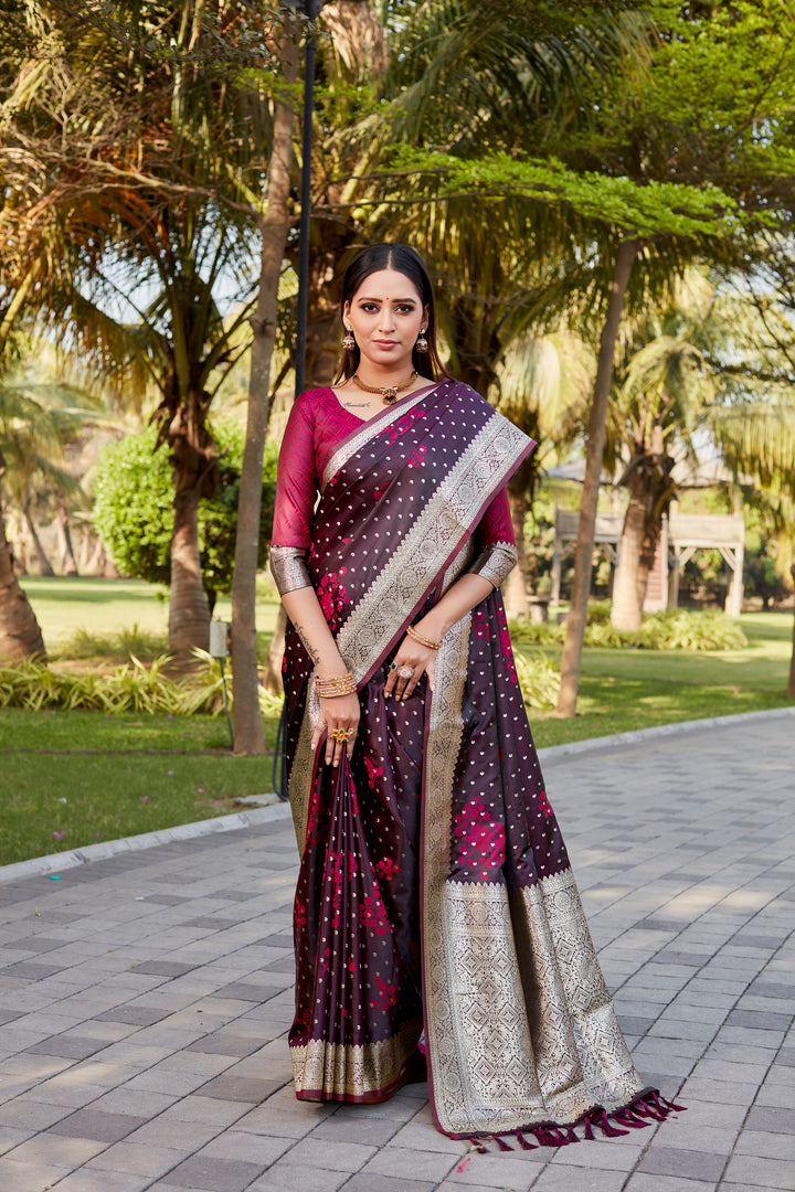 Rich wine Soft Satin Kanjivaram saree with detailed butta work and shimmering texture.