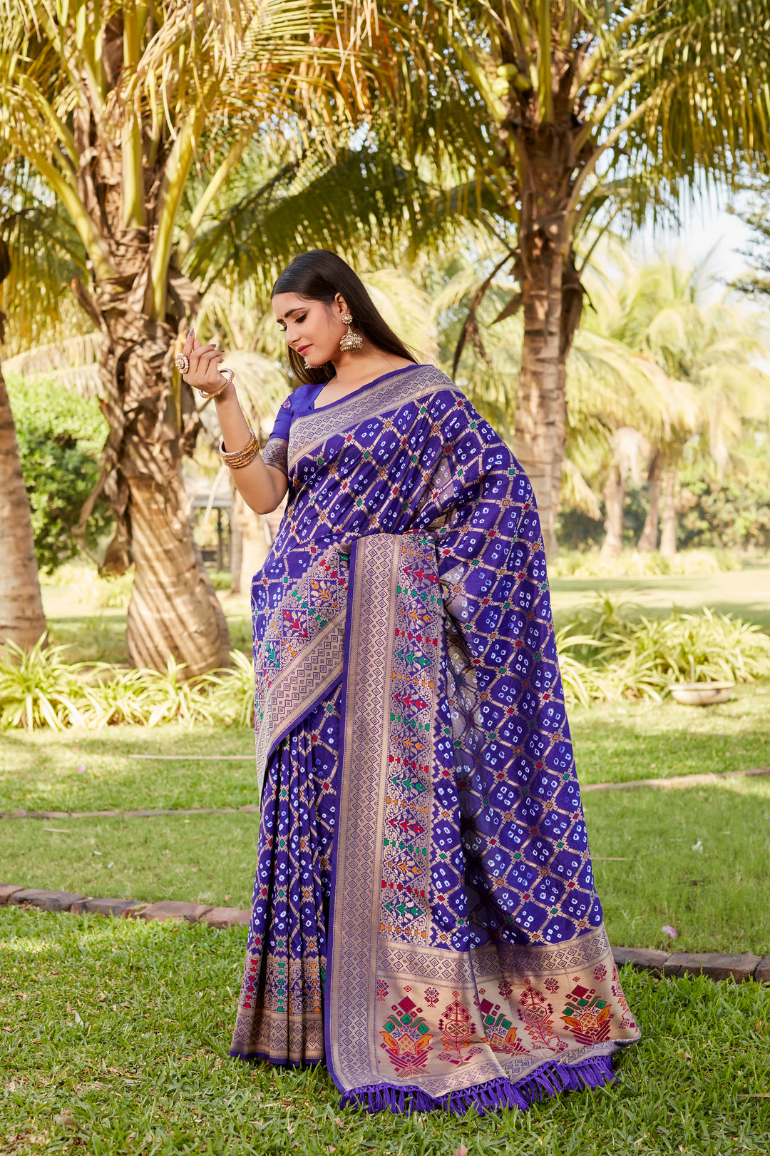 Black Gharchola Bandhej silk saree with intricate zari and meenakari borders, ideal for festive events and traditional gatherings.