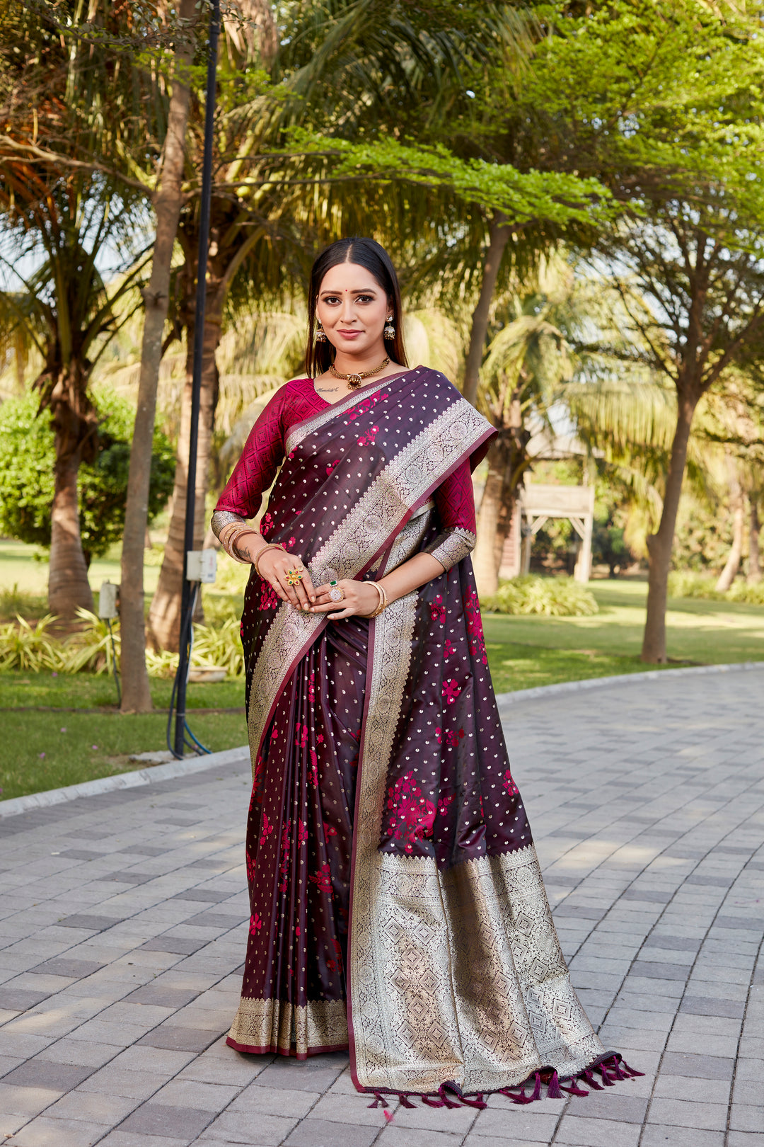 Wine Satin Kanjivaram saree with intricate butta design and a lustrous shimmering finish.