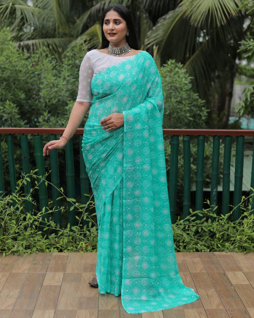 Stunning sea blue chiffon saree with luxurious foil detailing, perfect for weddings and special occasions.