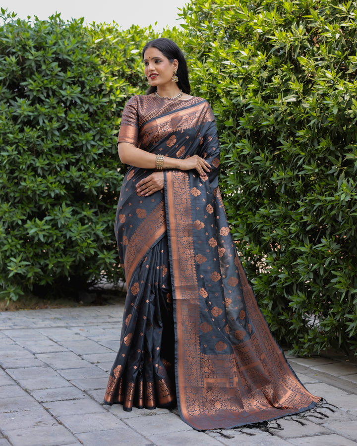 Timeless black soft silk saree featuring intricate copper weaving and a contrast border, perfect for elegant celebrations.