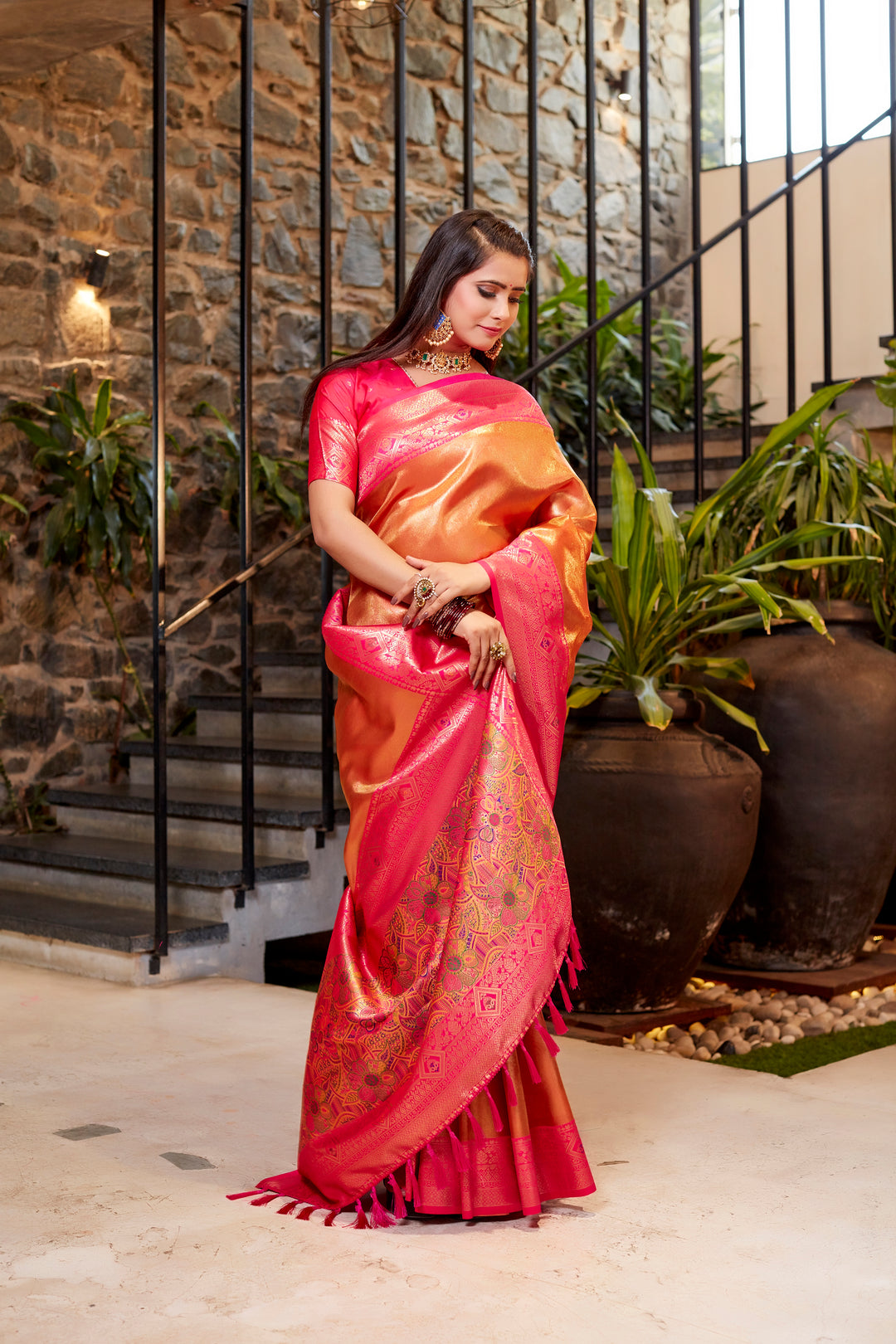 Timeless pink Tissue silk saree with intricate weaving and stunning contrast border.