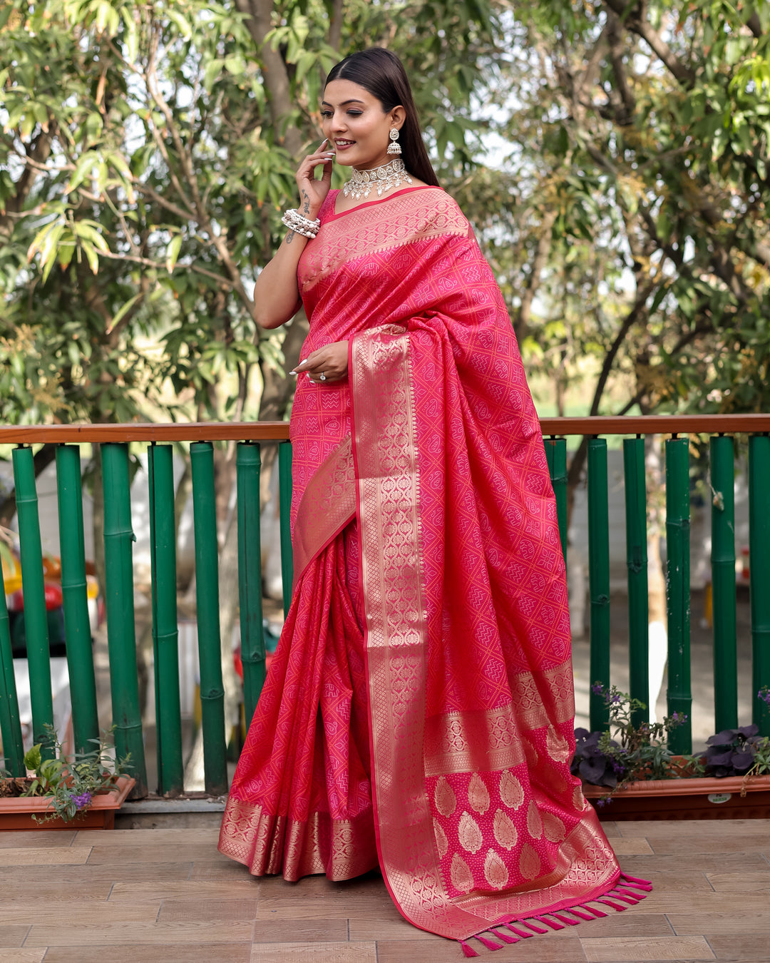 Designer saree in eye-catching bright pink, lightweight and soft for easy draping at cultural events.