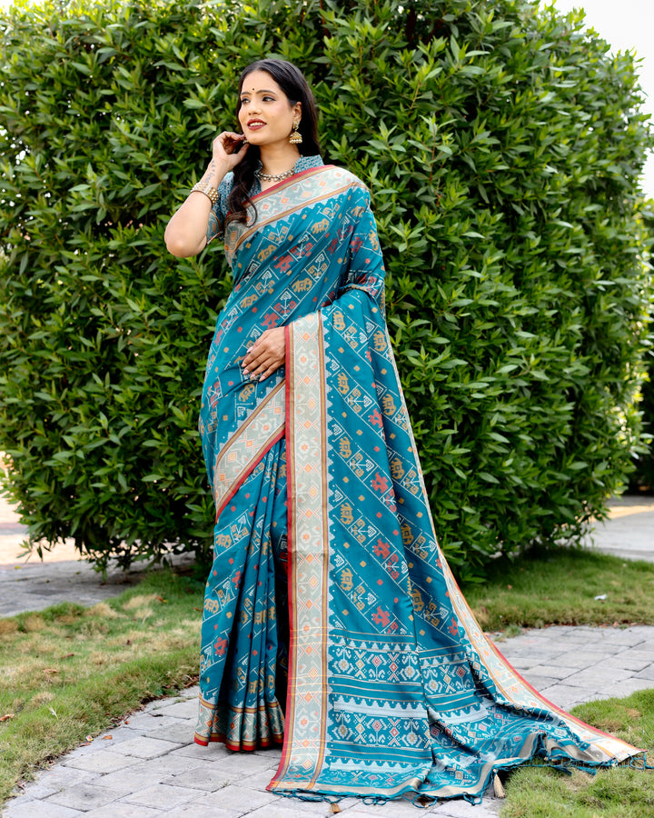 Elegant sea-blue Bandhej silk saree with zari woven pallu and matching blouse, perfect for festive and bridal wear.