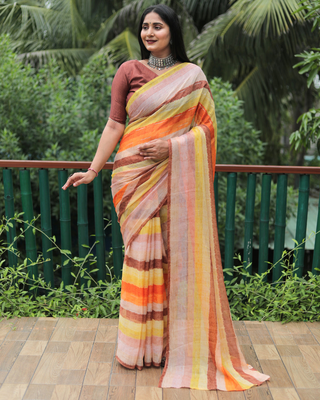 This multicolor Moss chiffon saree, designed with all-over prints and golden foil, is a perfect choice for weddings and festive events.