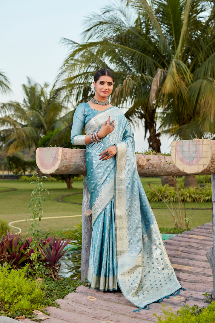 Elegant sky-blue Kanjivaram silk saree with intricate butta work and designer border, perfect for grand celebrations.