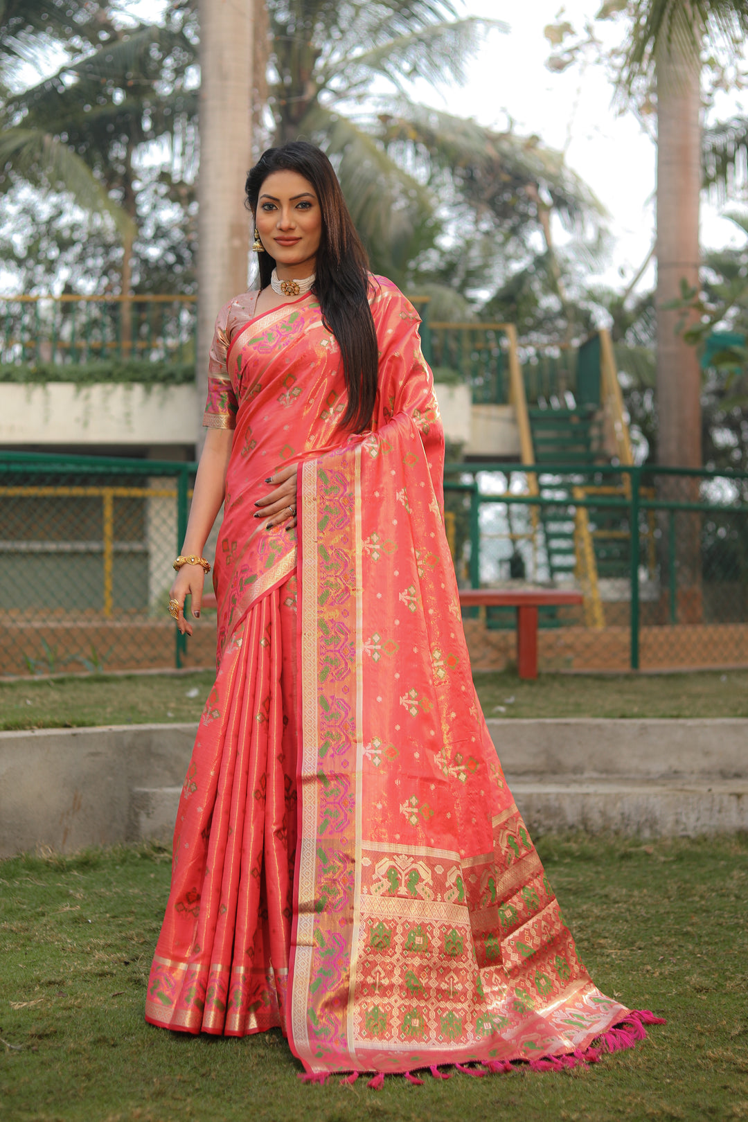 Beautiful dark-peach organza saree featuring Ikkat Patola design, perfect for cultural and traditional occasions.