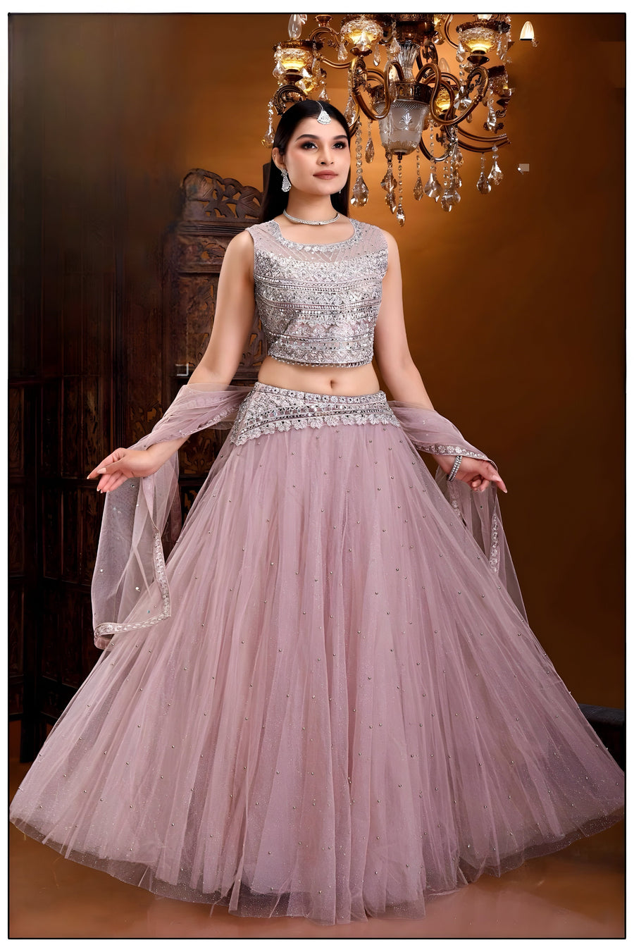 Pink floral crop top and skirt lehenga set made from comfortable net fabric, ideal for festive occasions.