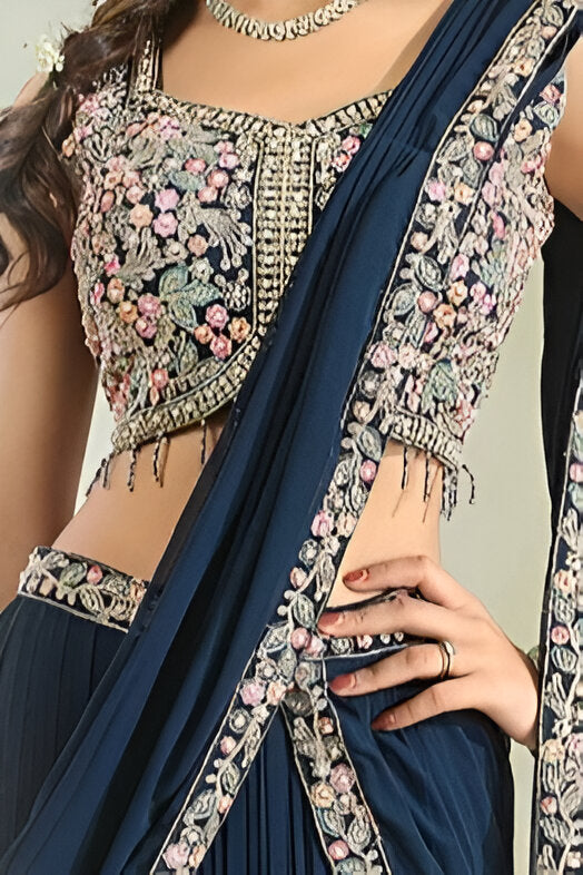 Chic navy blue saree with stunning floral artwork, ideal for special events.