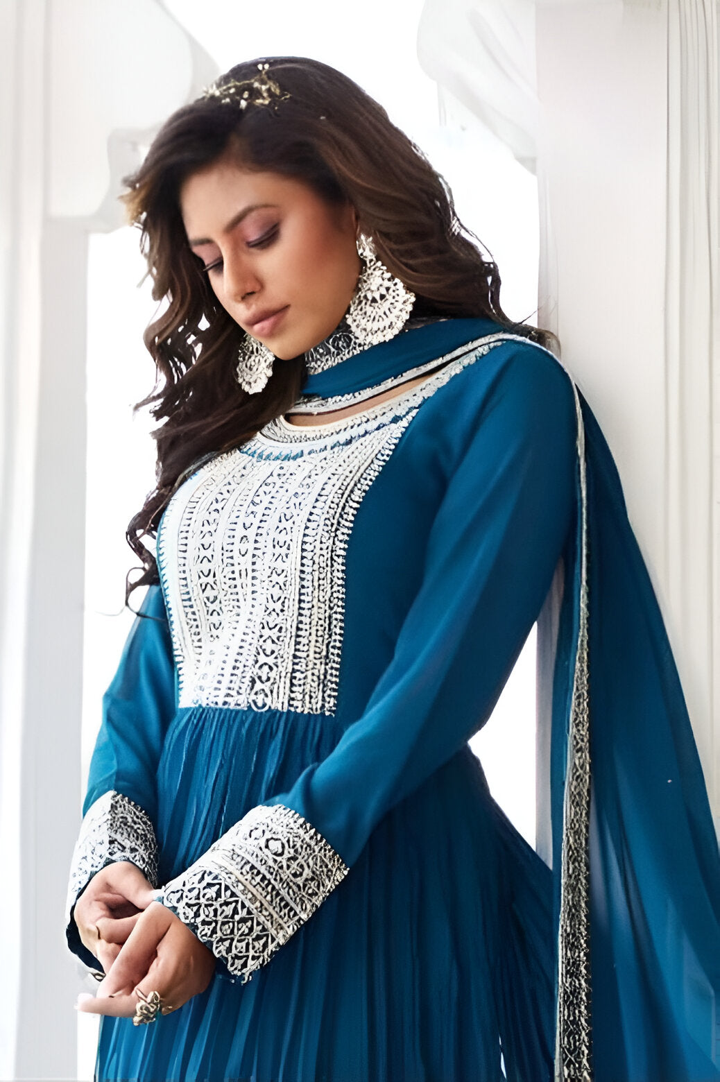 Stunning blue gown featuring a chic Anarkali design, ideal for formal occasions.