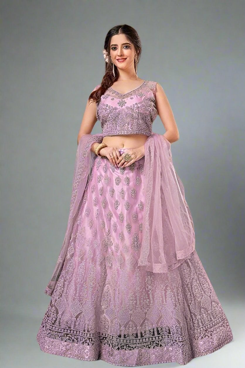 Elegant pink crop top lehenga set made from net fabric, perfect for weddings and festive celebrations.