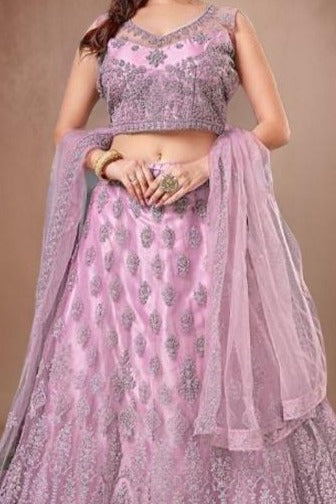 Stylish pink lehenga set with a crop top in delicate net fabric, ideal for making a statement at special occasions.