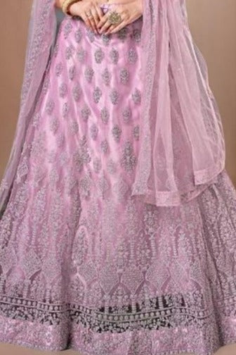 Chic pink lehenga set featuring a net fabric crop top, designed for elegance and comfort during festivities.