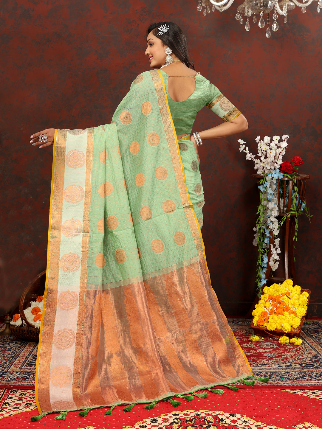 Elegant green cotton saree with stunning zari detailing, perfect for festive gatherings.