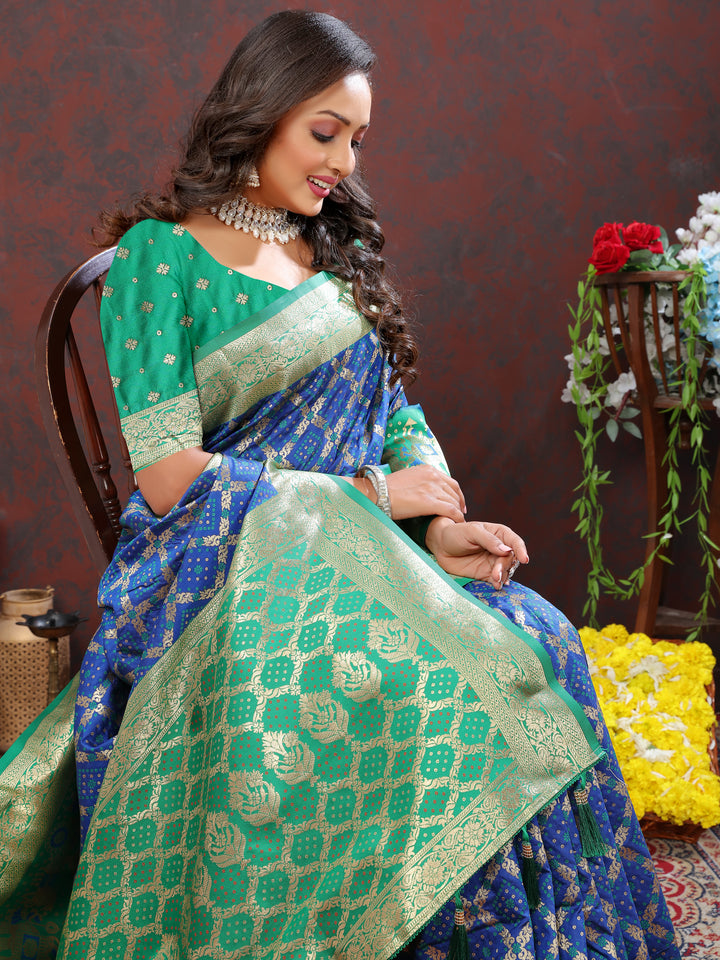 Stunning blue Patola silk saree with intricate Meenakari motifs and a zari border, offering a blend of tradition and elegance.