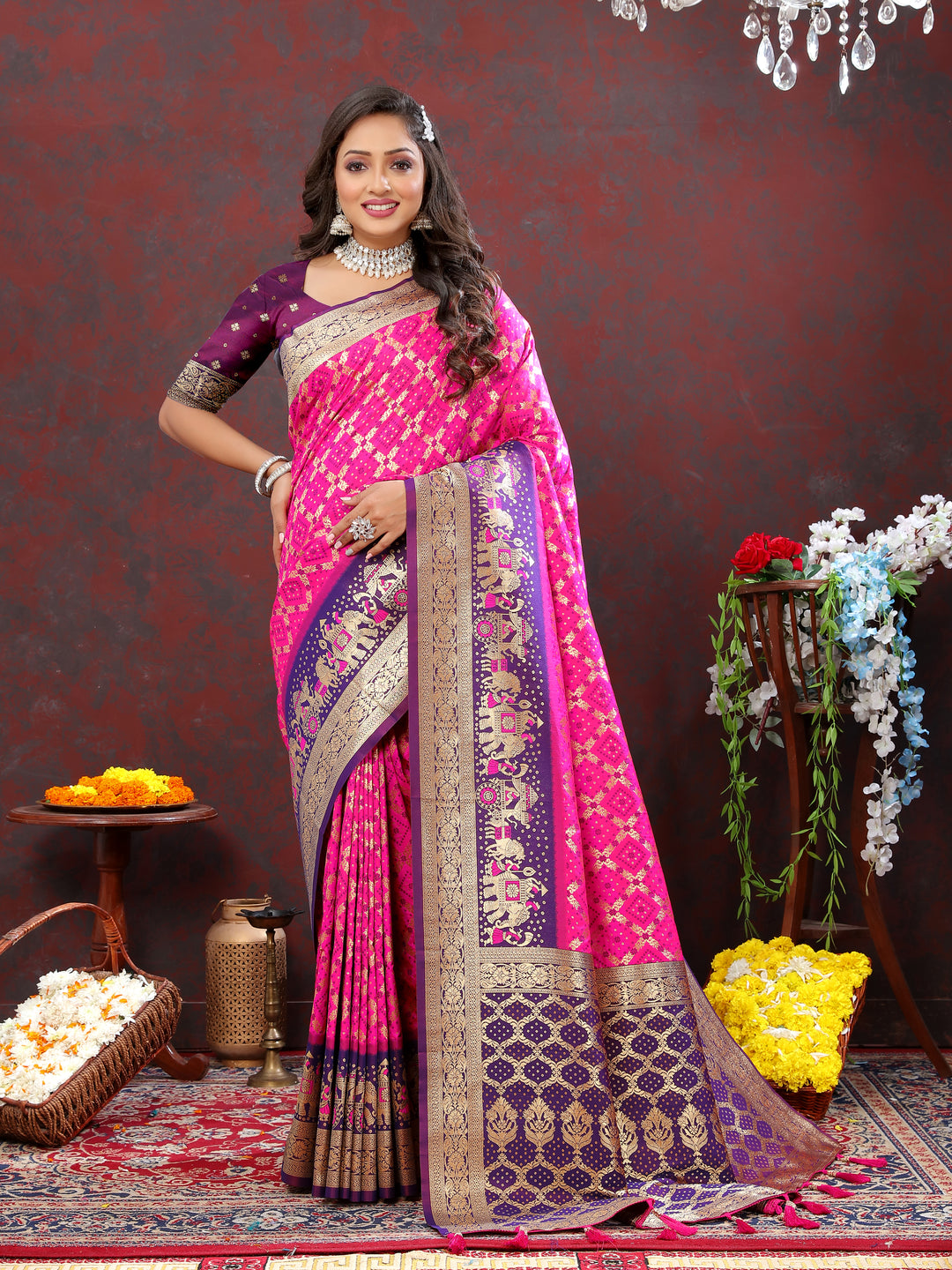 Elegant pink Patola silk saree with intricate Meenakari weaving and a zari border, perfect for weddings and festivals.