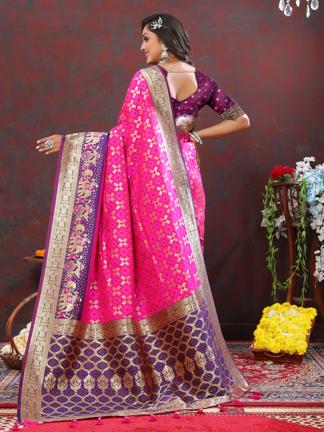 Stunning pink silk saree adorned with Meenakari weaving and a zari border, perfect for special occasions.