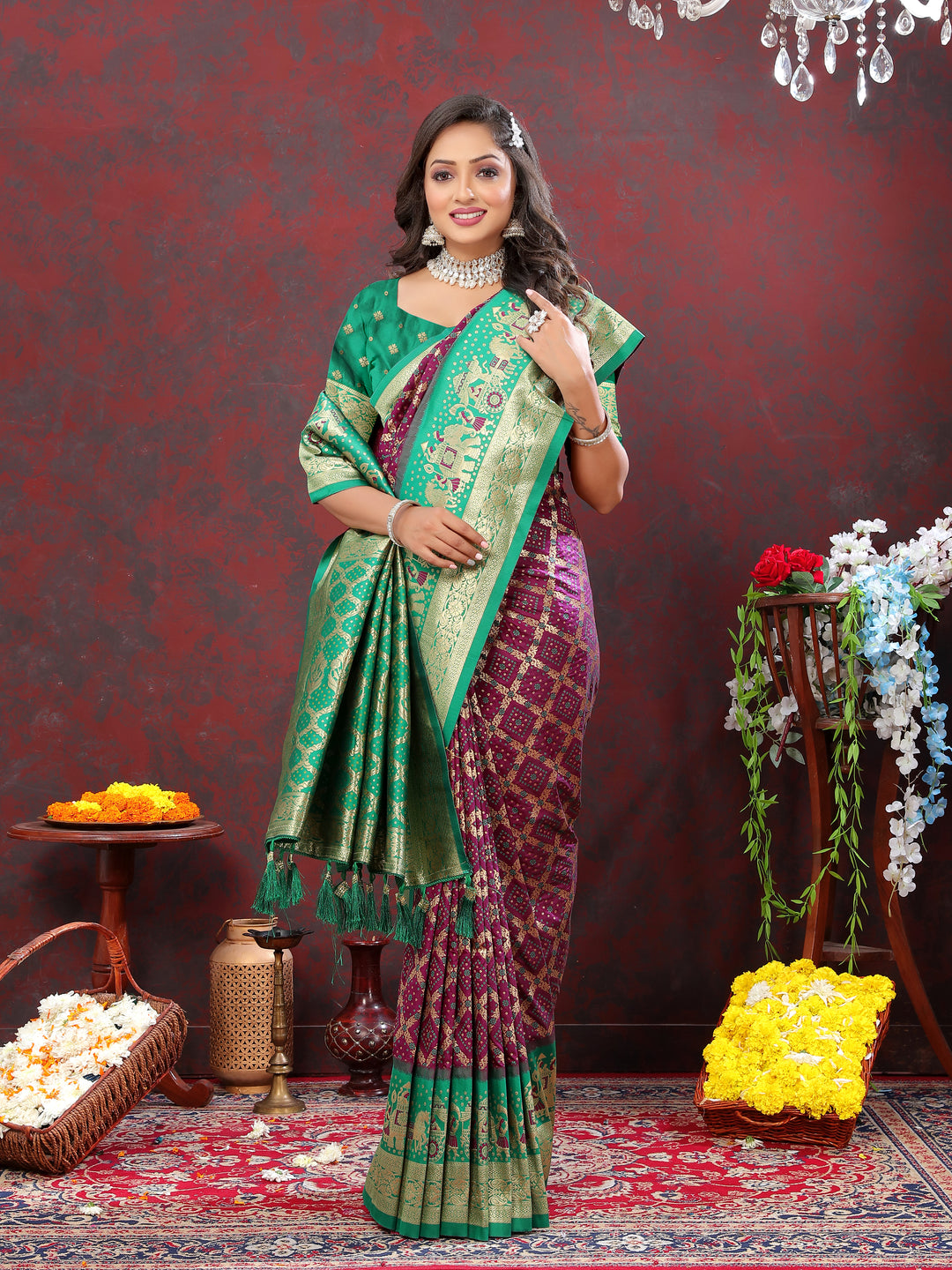 Rich wine Patola silk saree with Meenakari weaving and zari border, ideal for bridal wear and festive occasions.