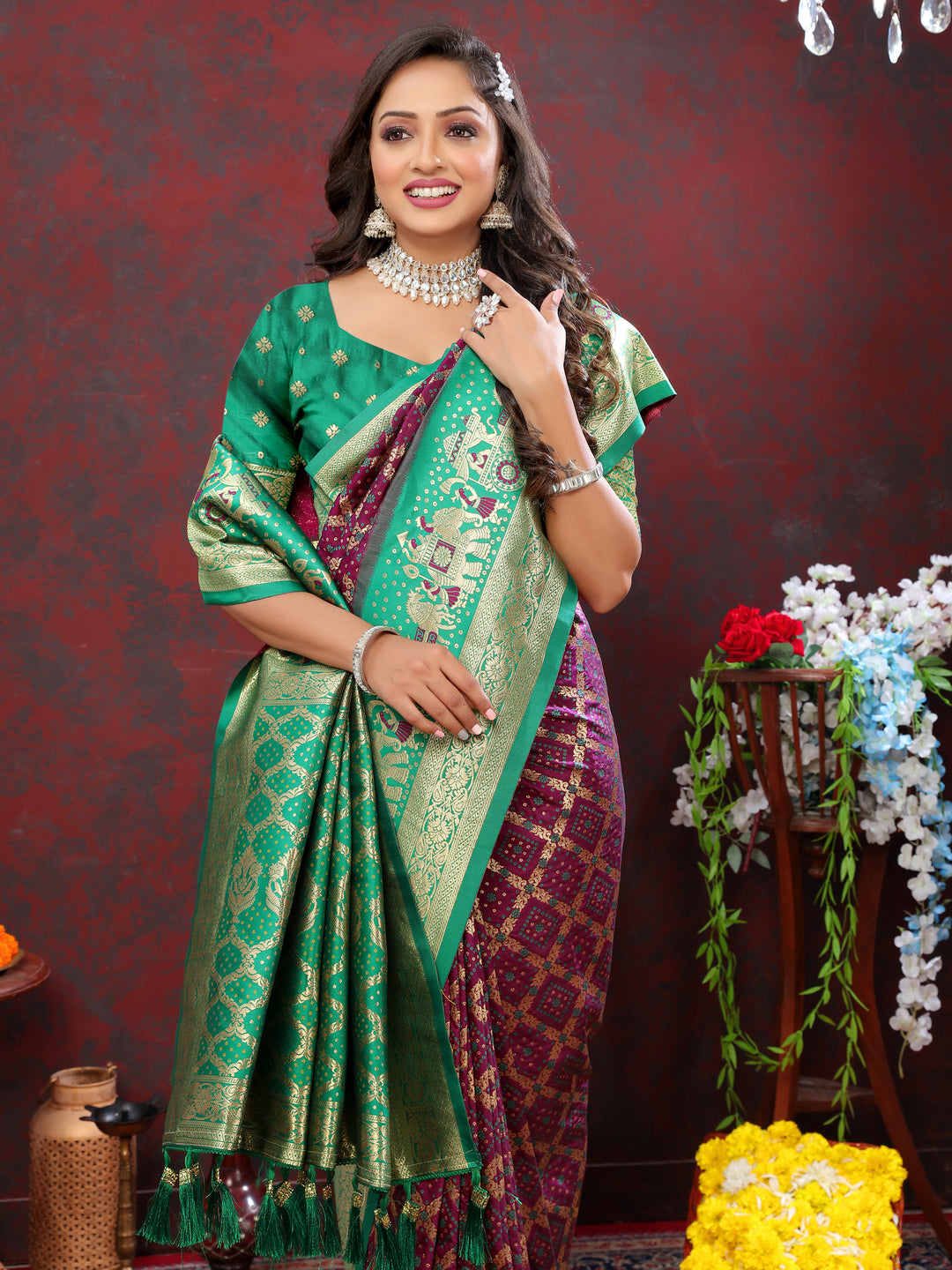 Wine silk saree featuring Meenakari motifs and zari border, designed for weddings and cultural celebrations.