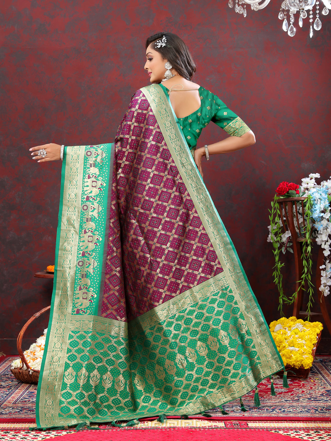 Wine Patola silk saree with Meenakari weaving and a zari border, ideal for traditional events and gatherings.