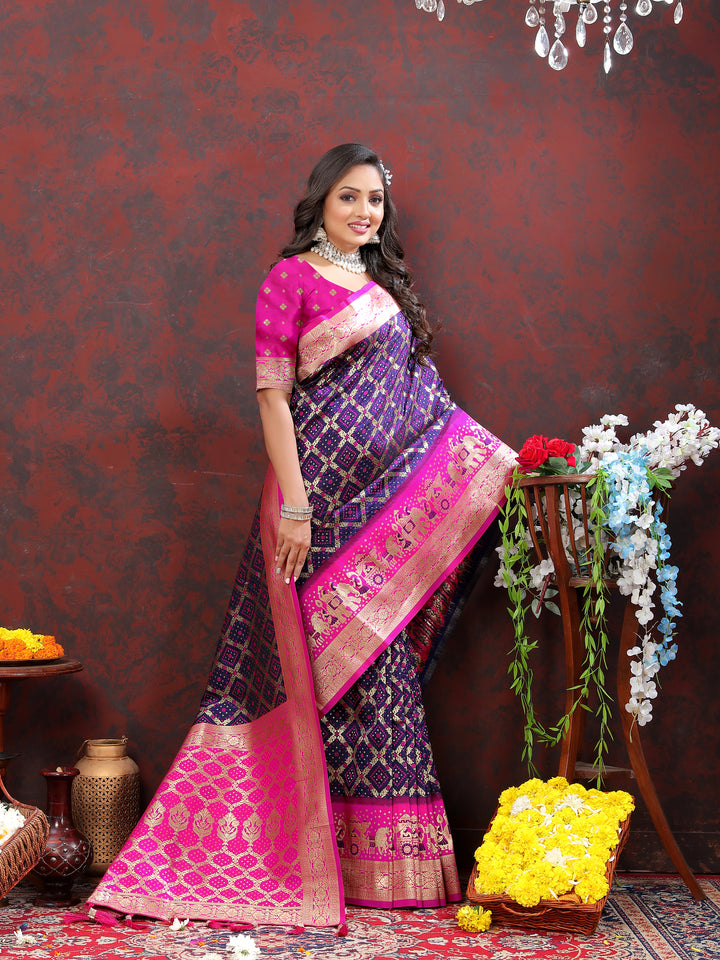 Rich wine Patola silk saree with Meenakari weaving and a zari border, ideal for bridal wear and special events.