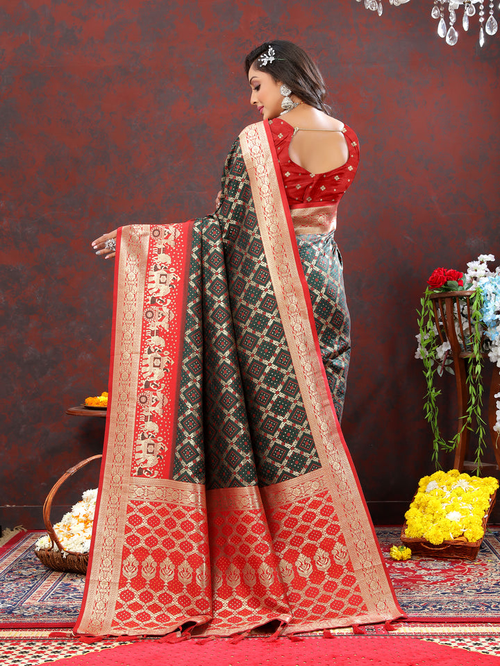 Olive silk saree with intricate Meenakari motifs and zari details, perfect for weddings and special occasions.